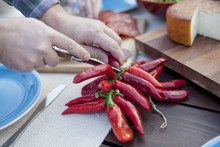 Person On Garden Party Slicing Red Pepper