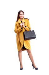 Portrait of fashion girl in yellow coat  posing on light backgro