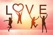 Happy valentines card. Silhouette of children girl jumping on tropical beach with fantastic sunset sky background. Kids holding the word LOVE with sea and sunrise background.