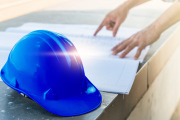 The blue safety helmet with the man verify blueprint for his pro