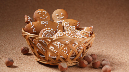 Wall Mural - Gingerbread cookies in the basket over cork background