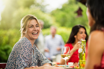 Poster - Group of friends having lunch, focus on a woman