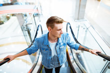 Portrait Of A Cool Guy Standing On Escalator