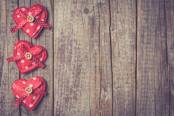 Poster - Red hearts on an old wooden table. Valentine's Day background