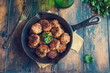 © Magrig - Homemade roasted beef meatballs in cast-iron skillet on wooden table in kitchen, fresh parsley, vintage fork, top view.