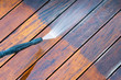 © bubutu - cleaning terrace with a power washer - high water pressure cleaner on wooden terrace surface