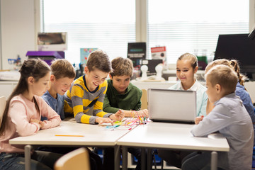 Wall Mural - happy children with laptop at robotics school