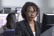 Young black professional woman working on computer at the office