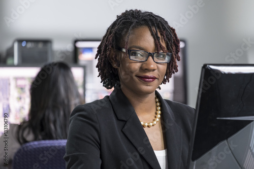 Fotografie, Obraz Young black professional woman working on computer at the office