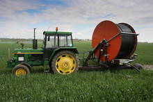 Old Green Tractor With Rainfall On Grain Field