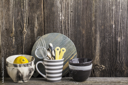 Fotovorhang - Cookware in gray and tools on a wooden kitchen shelf in the background rustic  wall. The horizontal design (von annaileish)