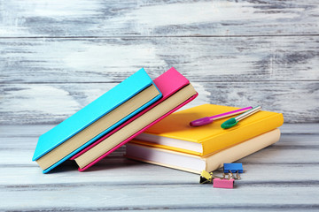 Sticker - Colorful books on wooden background