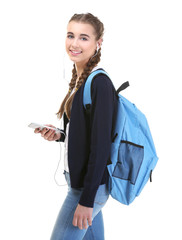 Wall Mural - Pretty teenager girl with backpack and phone on white background