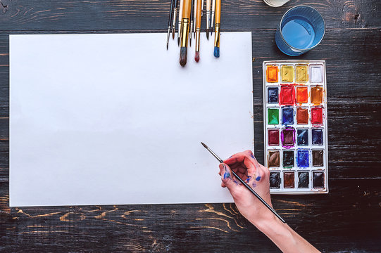 artistic brushes on wooden background