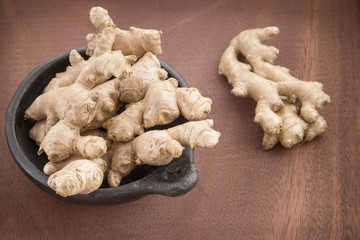 Ginger root on wooden table - Zingiber officinale