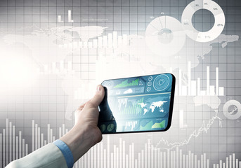 Media technology concept presented by businessman holding tablet with graphs and diagrams