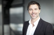 © annawin - Happy Businessman Smiling At The Camera At The Office