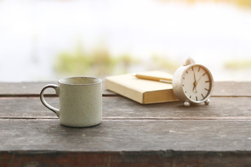 Wall Mural - Stock Photo:.coffee cup with notebook on wooden table