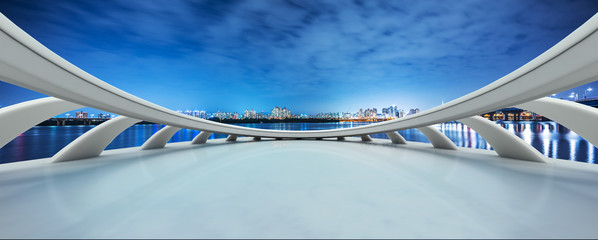 empty tile floor and modern bridge in seoul at night