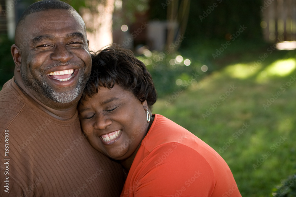 Mature African American couple laughing and hugging. Stock Photo ...