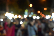 Blurred Image Of People Walking In Market At Night