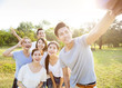 © Tom Wang - happy young group taking selfie in the park