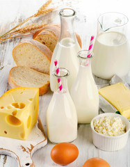 Wall Mural - Milk products, bread and eggs on a wooden table.