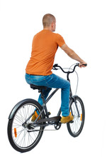 Back View Of A Man With A Bicycle. Cyclist Rides A Bicycle. Rear View People Collection.  Backside View Of Person. Isolated Over White Background. Man Riding A Bicycle