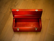 © stockedup - Empty red tool box on wooden floor