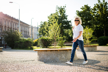 Stylish mature woman against modern urban environment