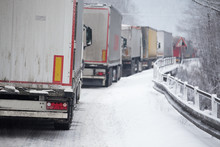 Traffic Jam Of Trucks In Snowstorm