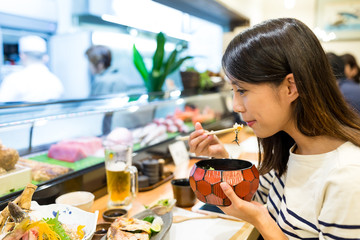 Sticker - Woman eating rice in japanese restaurant