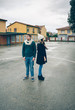 © David Pereiras - Serious young couple wearing winter clothes standing outdoors in a cold and rainy day