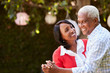 © Monkey Business - Senior black couple dancing in their backyard, close up