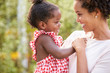 © Monkey Business - African American mother carries baby daughter and holds hand