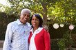 © Monkey Business - Senior black couple in their garden looking to camera