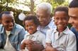 © Monkey Business - Multi generation male family members gathered in a garden