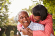 © Monkey Business - Senior black couple piggyback, looking at each other