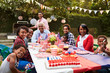 © Monkey Business - Multi generation black family having a 4th July garden party