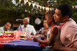 © Monkey Business - Black father and son at family 4th July barbecue, close up
