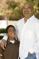 Wall Mural - Happy African American grandfather and grandson laughing.