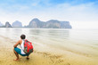 © engkritchaya - Traveler backpack looking mountain and sea view in evening.Or traveler man with sea view