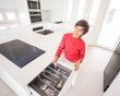 © Jasmin Merdan - A boy standing in new modern kitchen