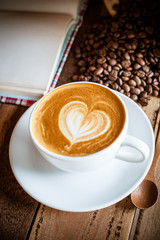 Wall Mural - cup of coffee with cream on wooden background