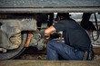 Mechanic stoop for adjust the wheel of train.