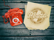 © Maksym Yemelyanov - Pizza ordering and delivery concept. Vintage telephone and pizza