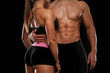 © Africa Studio - Sporty young couple on black background, closeup