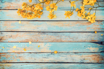 yellow flowers on vintage wooden background, border design. vintage color tone - concept flower of s
