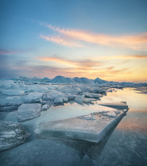 Wall Mural - Frozen sea during sunset. Beautiful natural seascape in the winter time