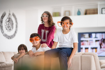 Wall Mural - Funny kids with silly glasses on eyes at home